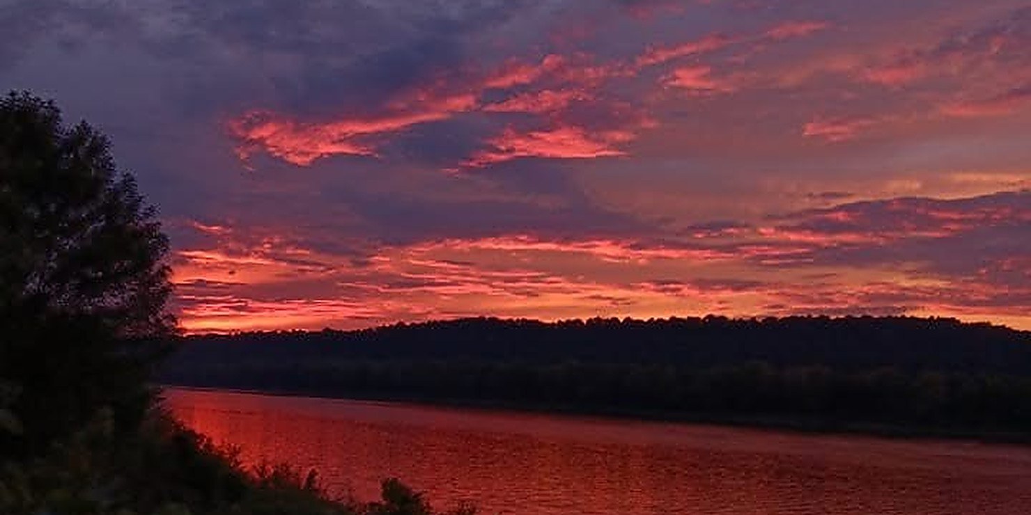 Red clouds over the river at dusk